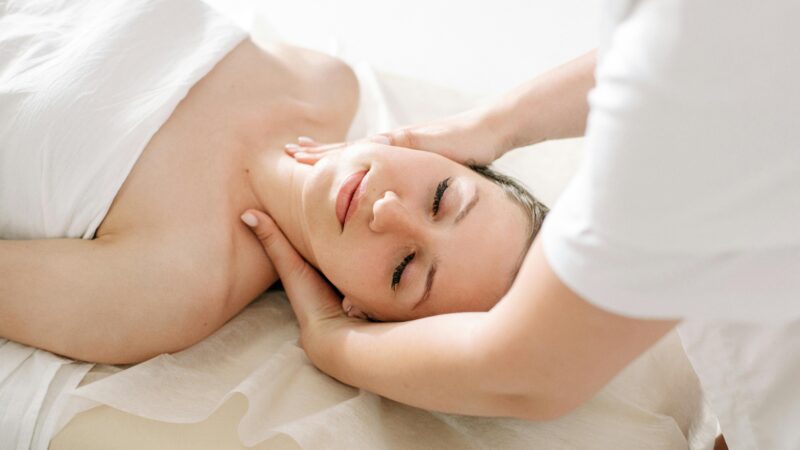 A serene spa treatment capturing a woman receiving a relaxing massage, symbolizing therapeutic wellness.