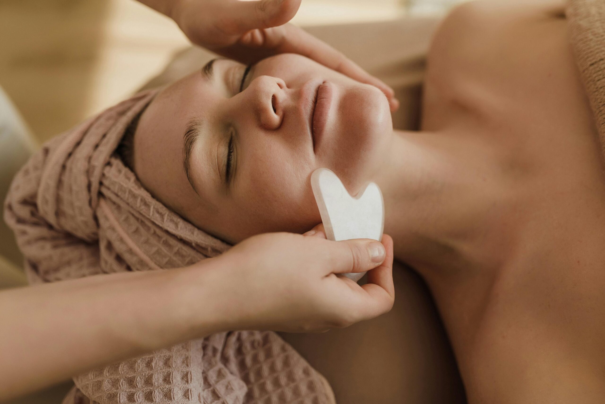 Calming spa experience with gua sha facial massage promoting skincare and relaxation.
